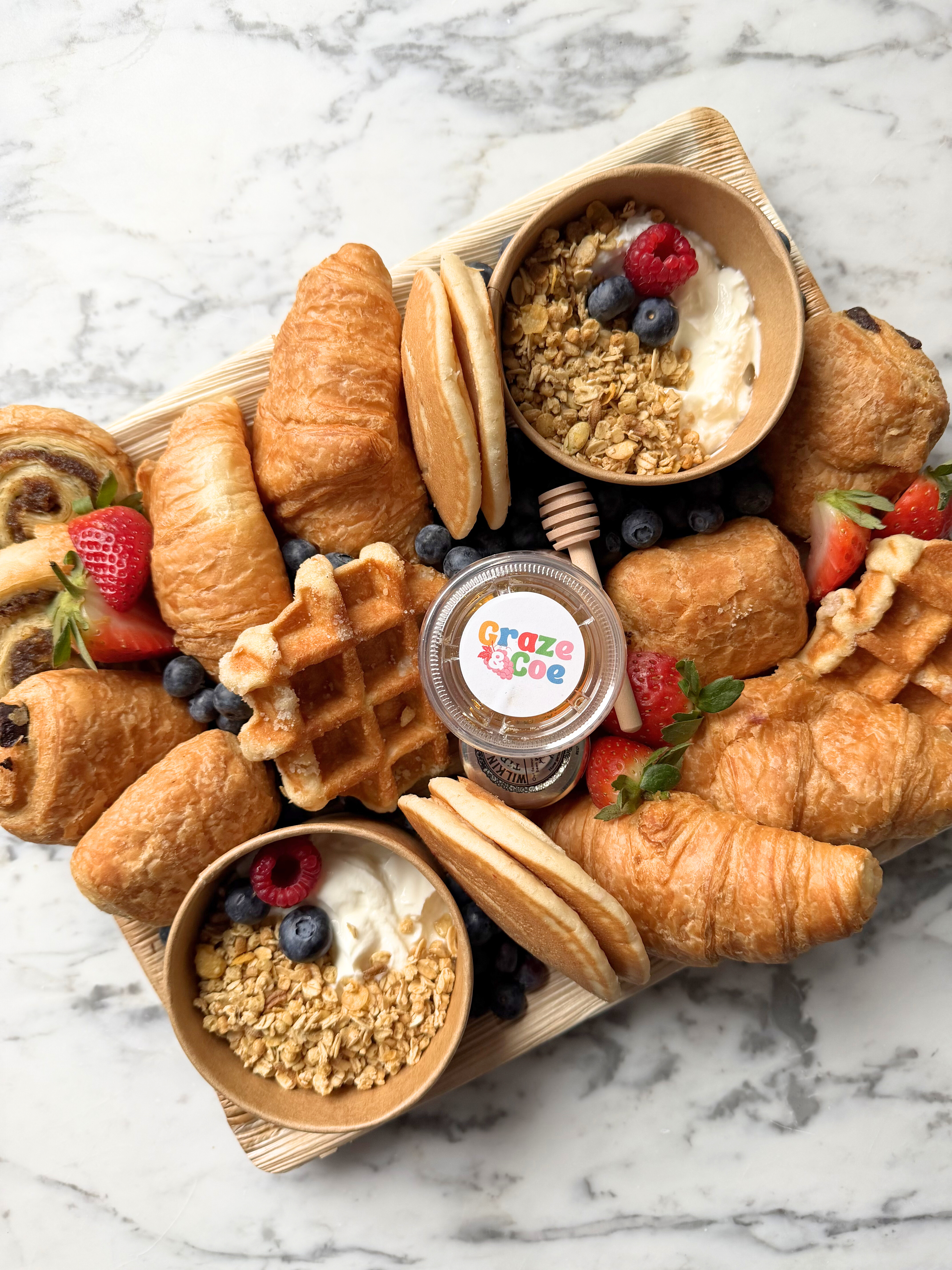 The Breakfast Club grazing board with pastries, fruit, yoghurt and brunch bites