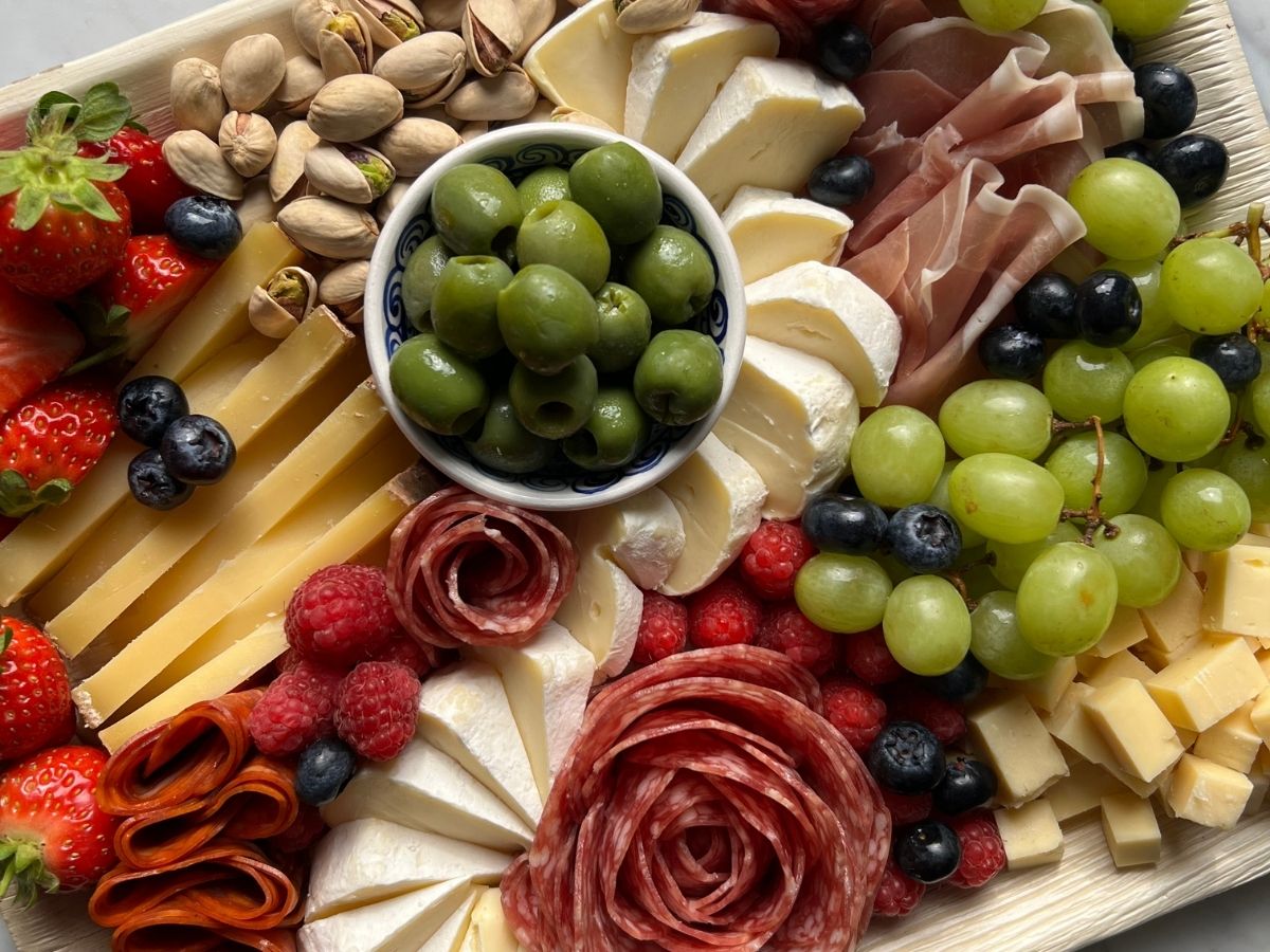 The Main Character grazing board with cheeses, cured meats, and fruit