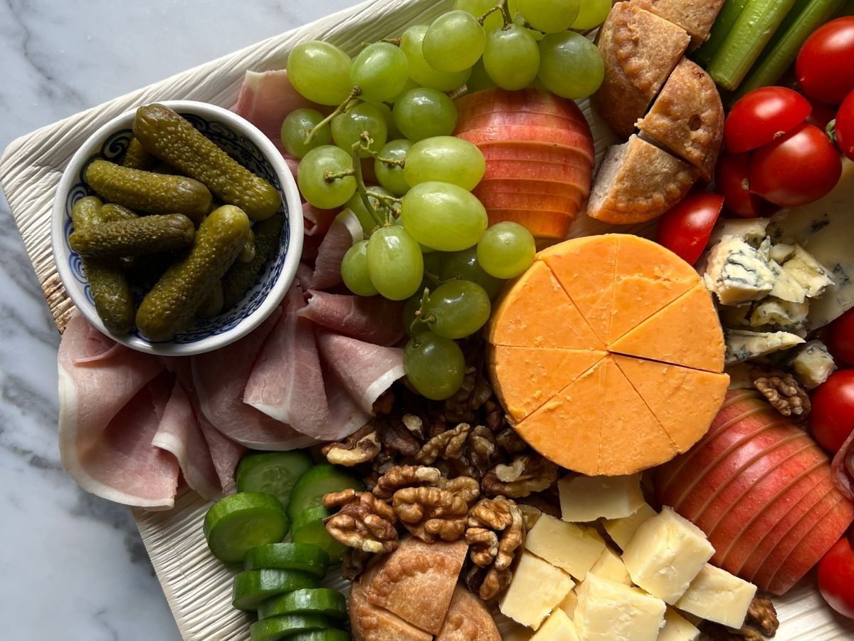 The Ploughmans grazing board with British cheeses, hams and chutney